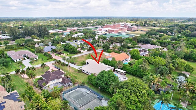 aerial view of property and surrounding area featuring nearby suburban area