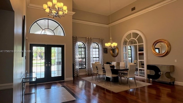 entrance foyer featuring visible vents, wood finished floors, french doors, baseboards, and a chandelier