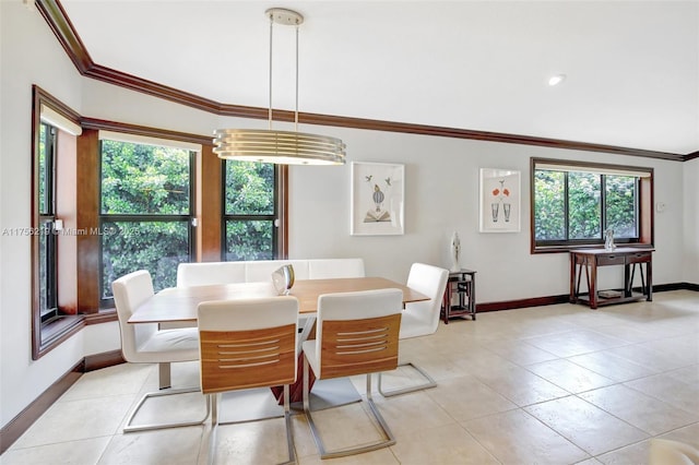 dining area with baseboards, healthy amount of natural light, ornamental molding, and light tile patterned flooring