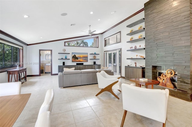 living area featuring ornamental molding, ceiling fan, a fireplace, light tile patterned floors, and baseboards