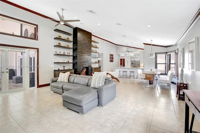 living area featuring crown molding, light tile patterned floors, ceiling fan, and recessed lighting