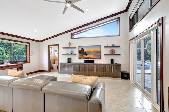 living area with light tile patterned floors, ornamental molding, a ceiling fan, baseboards, and high vaulted ceiling