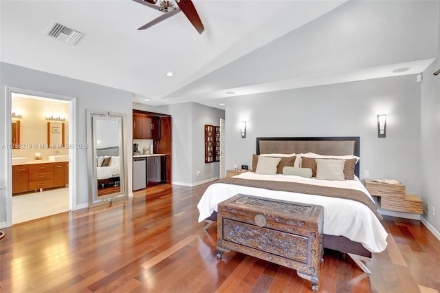bedroom with vaulted ceiling, light wood-style floors, baseboards, ceiling fan, and connected bathroom