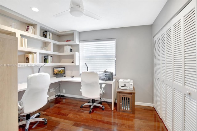 office space featuring wood finished floors, ceiling fan, and baseboards