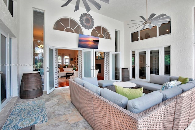 view of patio featuring french doors, a ceiling fan, and an outdoor living space