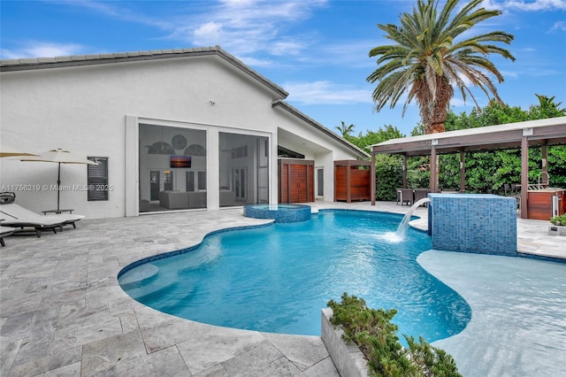 view of swimming pool with a patio area and a pool with connected hot tub