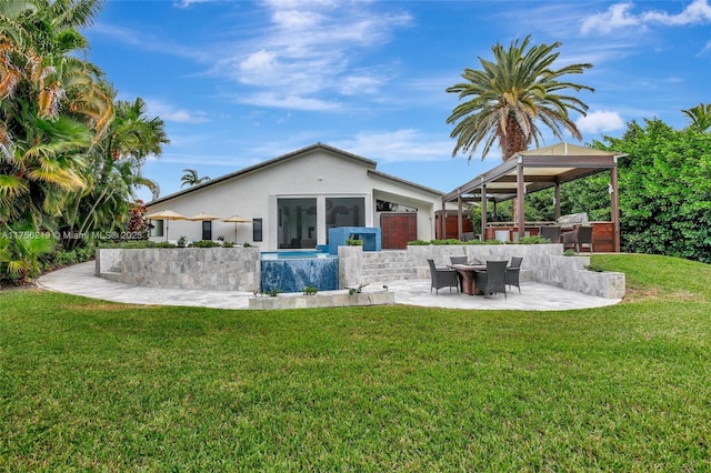 rear view of house featuring exterior kitchen, stucco siding, a gazebo, a yard, and a patio area