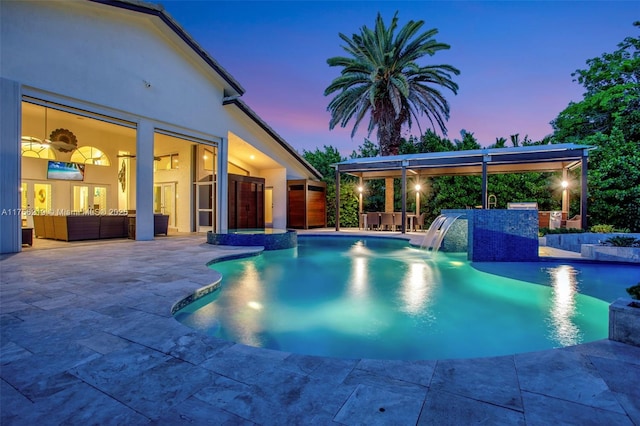 pool at dusk with a patio, an outdoor pool, and area for grilling