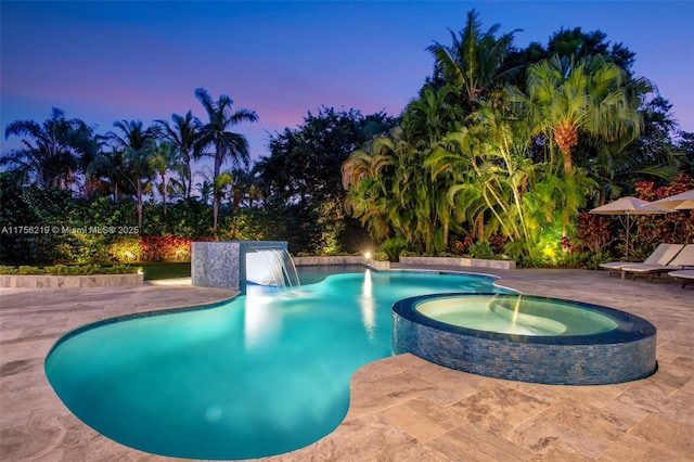 view of pool with a patio area and a pool with connected hot tub