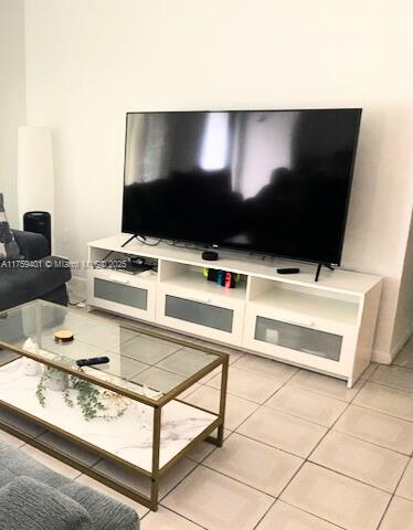 living area featuring light tile patterned flooring