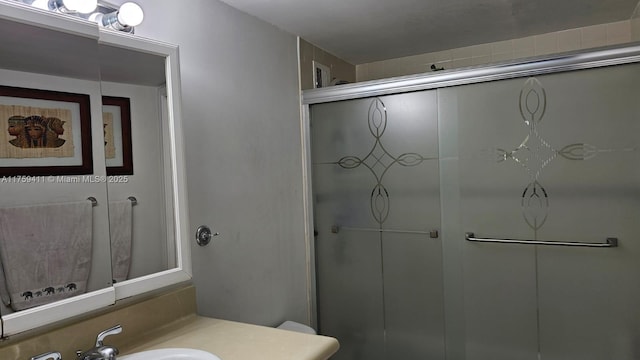 full bath with a shower stall, toilet, and vanity