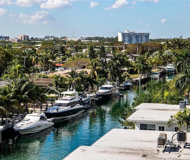 dock area with a view of city, central AC unit, and a water view