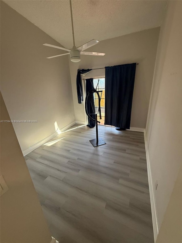 990 NE 212th Ter Unit 990-03, Miami, FL 33179 - interior space featuring baseboards, ceiling fan, wood finished floors, vaulted ceiling, and a textured ceiling