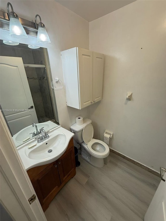 990 NE 212th Ter Unit 990-03, Miami, FL 33179 - bathroom featuring baseboards, toilet, wood finished floors, vanity, and a shower stall