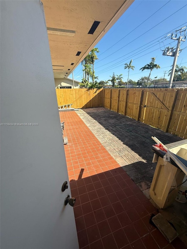 990 NE 212th Ter Unit 990-03, Miami, FL 33179 - view of patio / terrace featuring fence