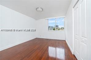 interior space with baseboards and wood finished floors