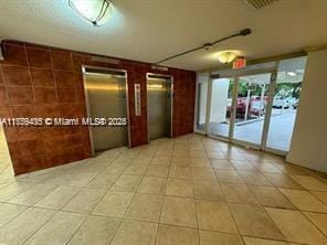 unfurnished room with visible vents and elevator