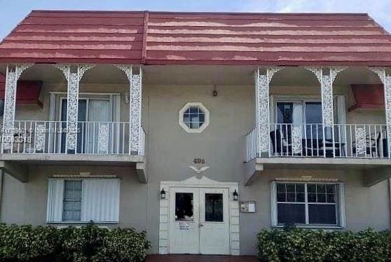 doorway to property featuring stucco siding