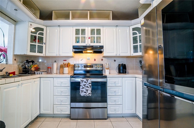 kitchen featuring under cabinet range hood, a sink, tile counters, smart refrigerator, and stainless steel range with electric stovetop