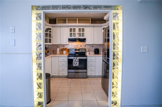 kitchen featuring light tile patterned flooring, electric range, white cabinets, backsplash, and range hood