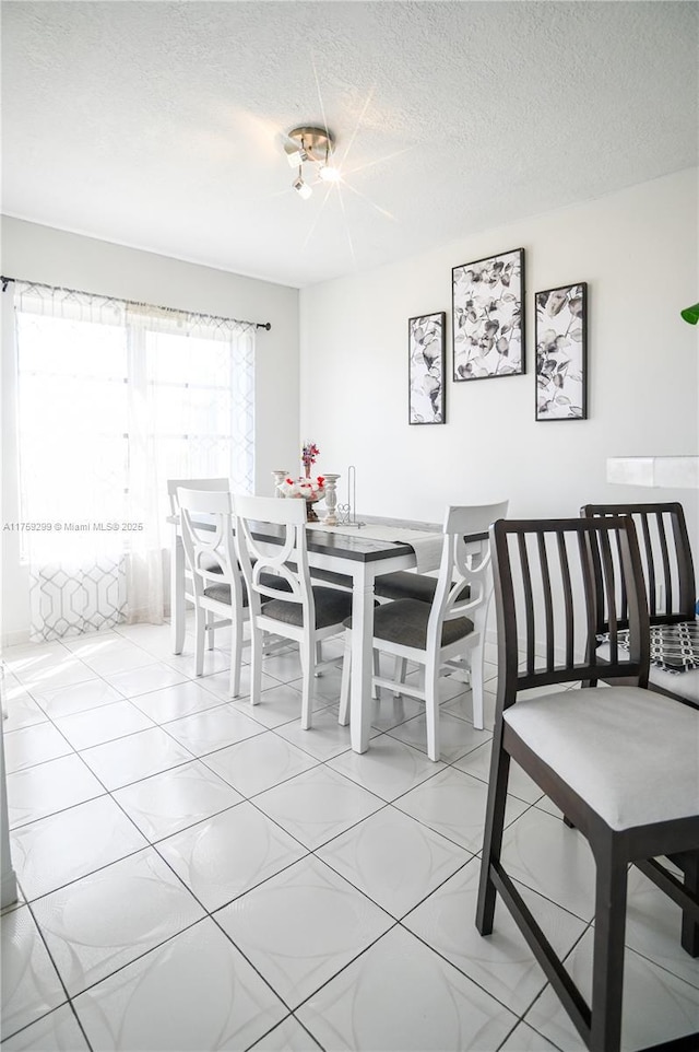 dining space with a textured ceiling