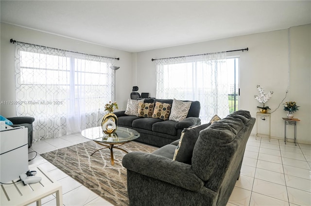 living room featuring a wealth of natural light and light tile patterned flooring