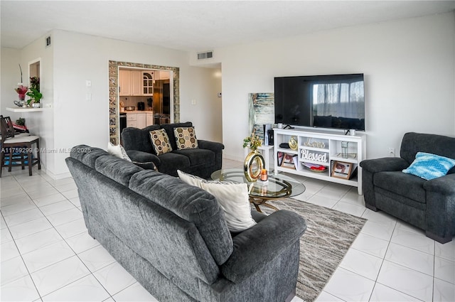 tiled living room featuring visible vents