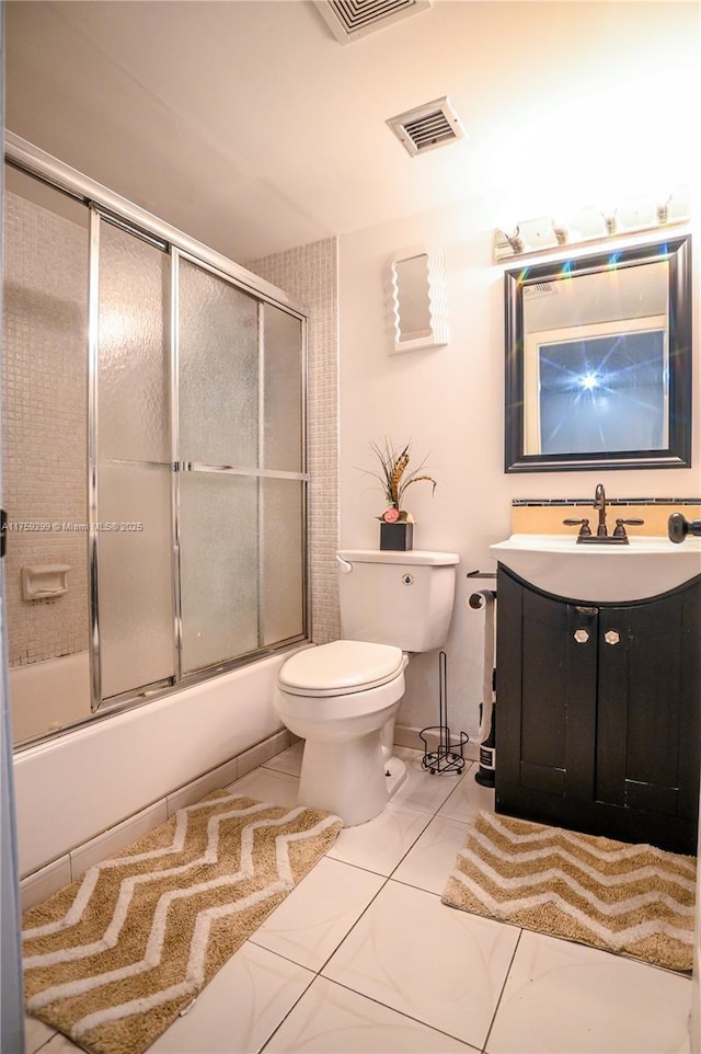 bathroom with toilet, enclosed tub / shower combo, visible vents, and vanity