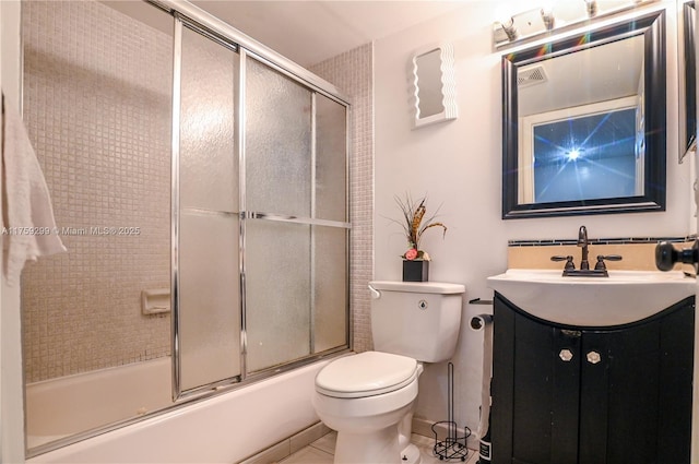 full bathroom featuring toilet, shower / bath combination with glass door, and vanity