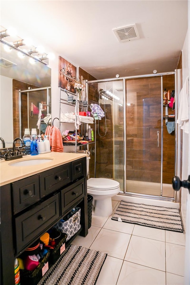 full bath featuring a stall shower, tile patterned flooring, visible vents, and vanity