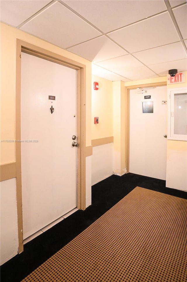 hallway featuring a paneled ceiling