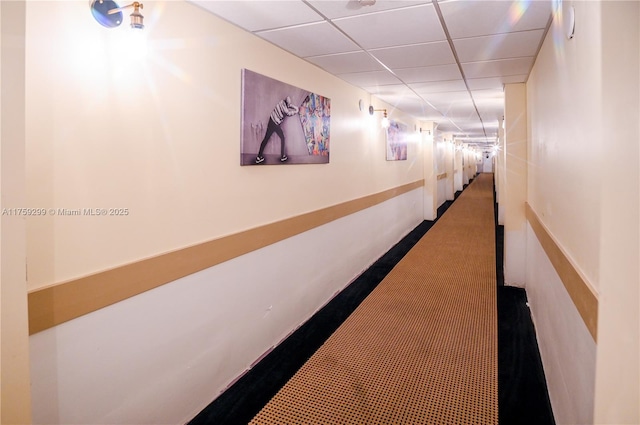 hall with a paneled ceiling