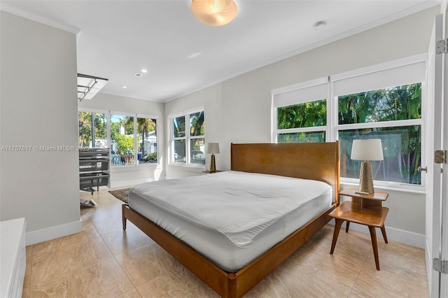 bedroom featuring baseboards and crown molding