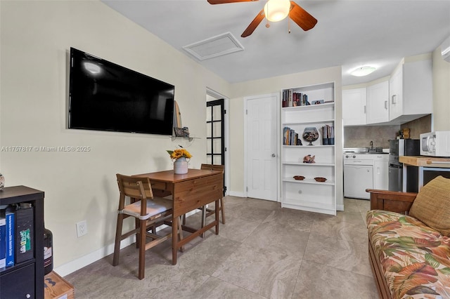 living area with attic access and baseboards