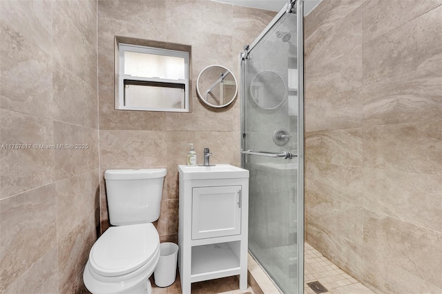 full bathroom featuring a stall shower, vanity, and toilet