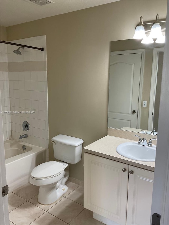 full bath featuring tile patterned floors, toilet, vanity, and bathing tub / shower combination