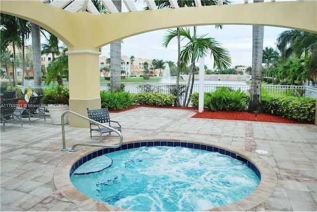 view of swimming pool with a patio area and fence