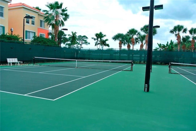 view of sport court featuring fence