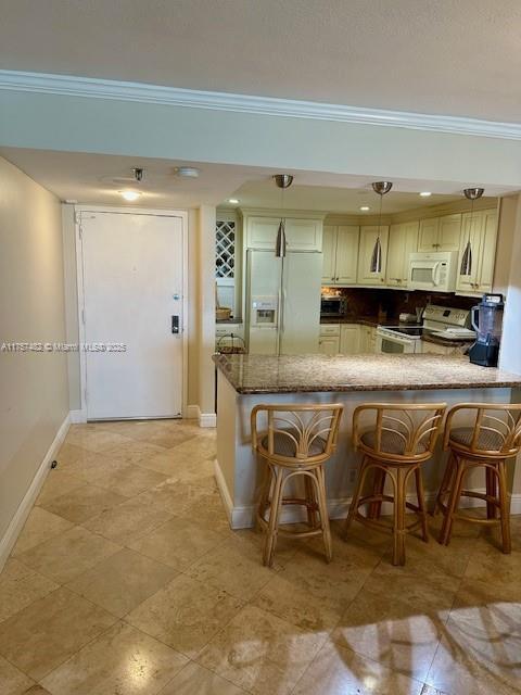 kitchen with a peninsula, white appliances, backsplash, and crown molding