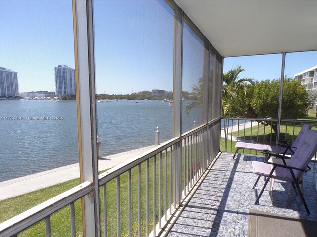 unfurnished sunroom with a water view