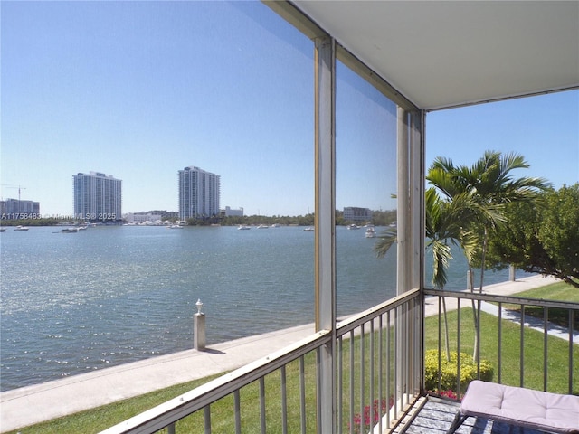 balcony featuring a water view and a view of city