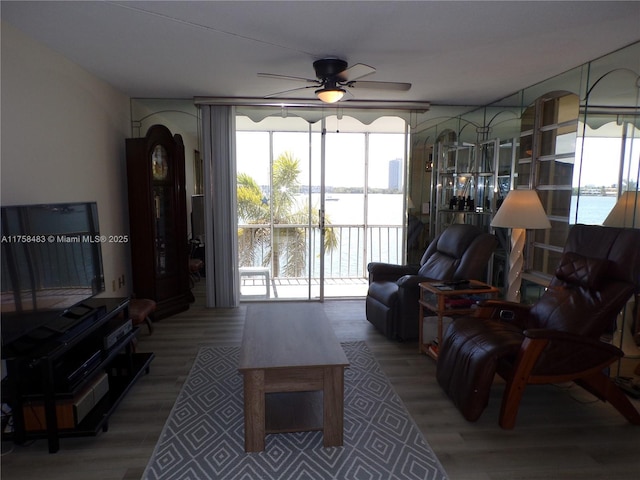 living area featuring wood finished floors and a ceiling fan