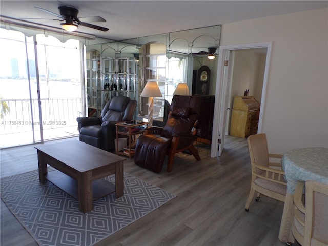 living room with ceiling fan and wood finished floors