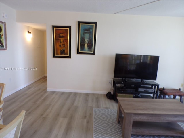 living room featuring baseboards and wood finished floors