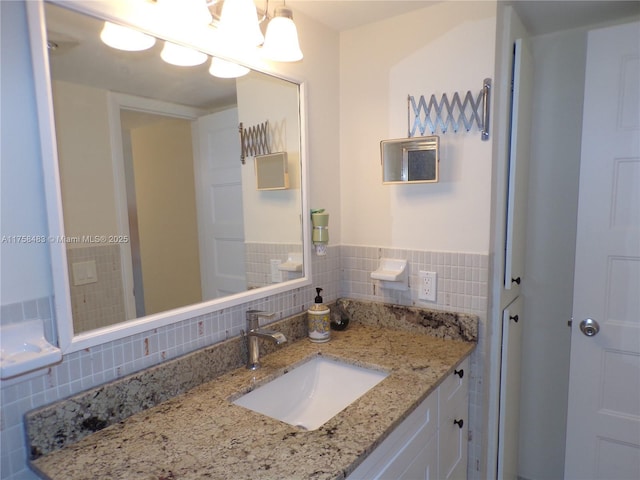 bathroom featuring tile walls and vanity