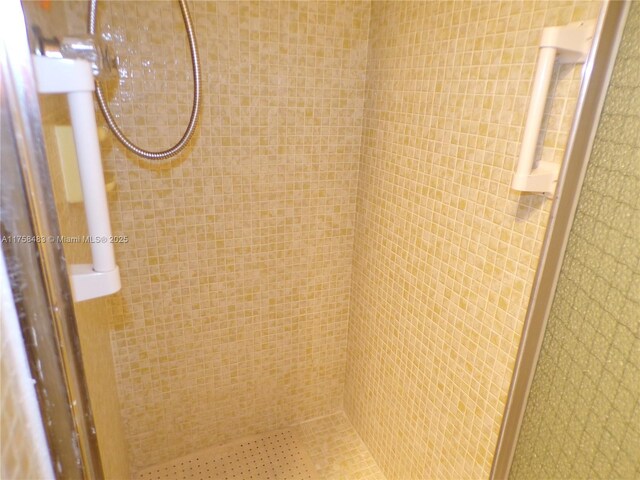 interior details featuring a stall shower