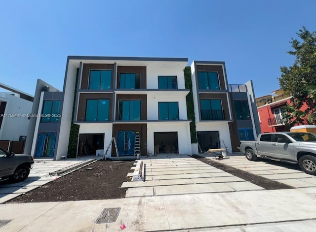 exterior space with a garage, driveway, and stucco siding