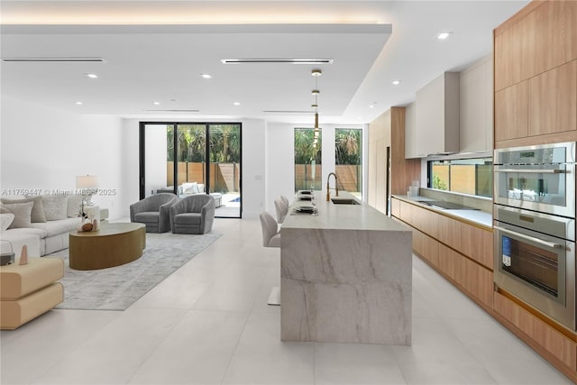 1823 NE 26th Ave, Fort Lauderdale, FL 33305 - kitchen with an island with sink, a sink, modern cabinets, open floor plan, and black electric cooktop