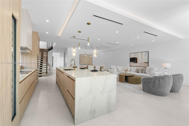 1823 NE 26th Ave, Fort Lauderdale, FL 33305 - kitchen with modern cabinets, recessed lighting, light brown cabinets, a sink, and a large island