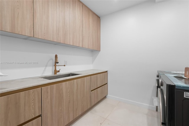 1823 NE 26th Ave, Fort Lauderdale, FL 33305 - clothes washing area with baseboards, washing machine and dryer, a sink, cabinet space, and light tile patterned floors